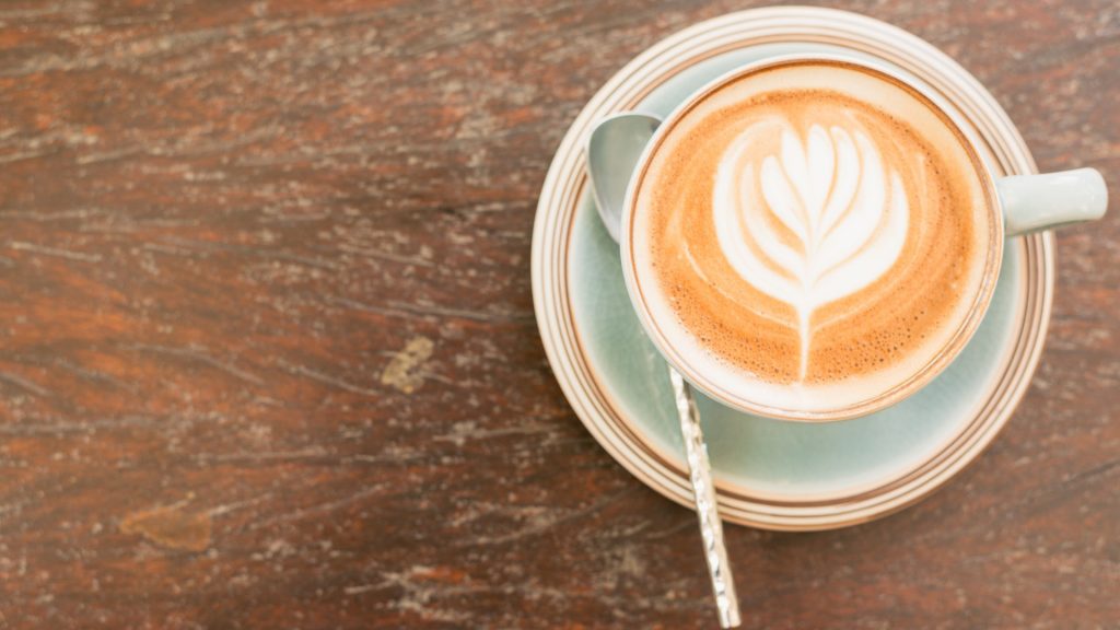 Kaffeetasse von oben auf eine braunen Tisch