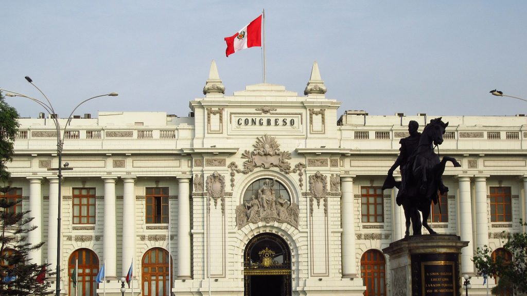 Der peruanische Kongress in Lima, weißes Gebäude mit Säulen, auf dem Dach eine peruanische Flagge.