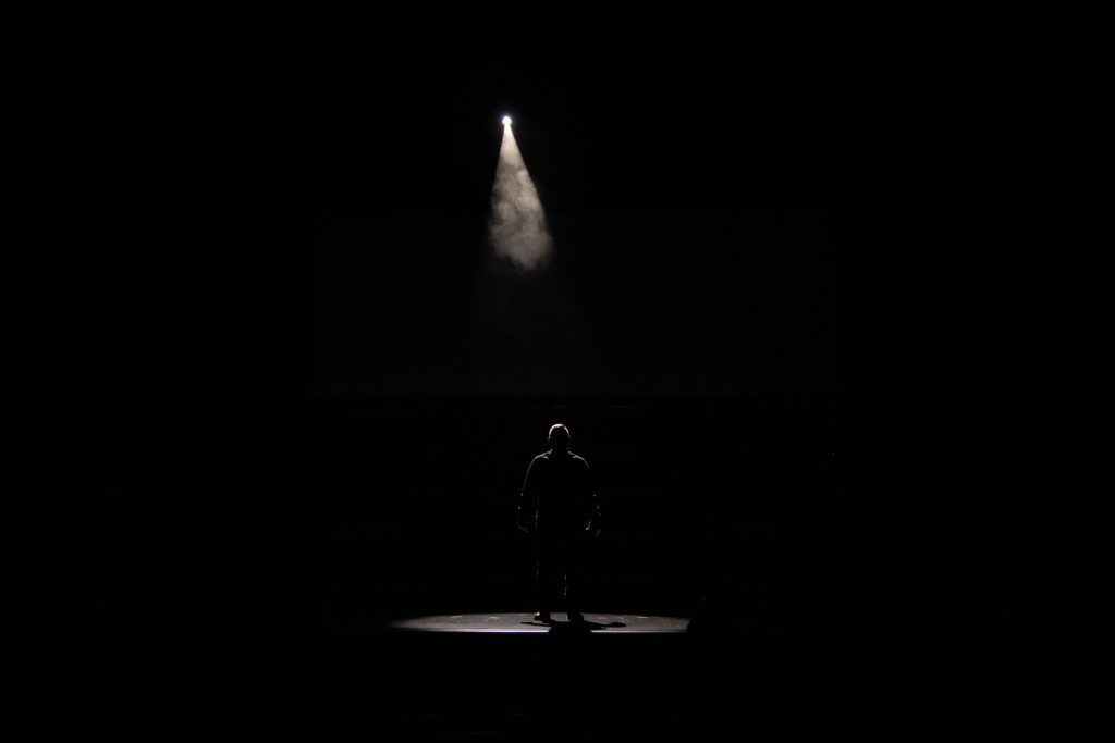 Person alleine im Scheinwerferlicht