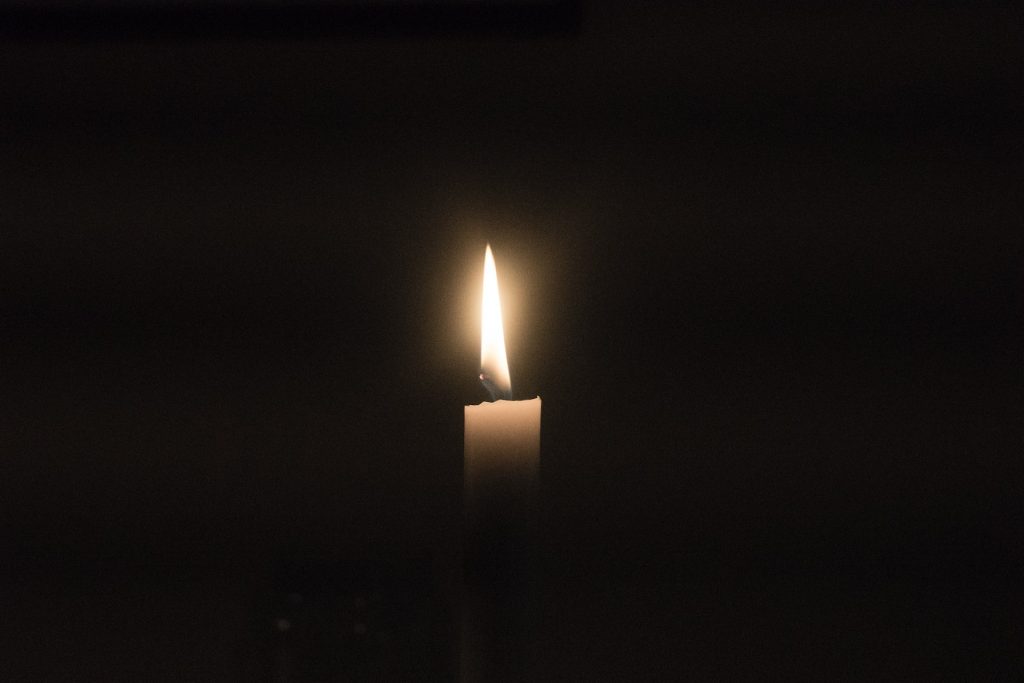 Kerze vor schwarzem Hintergrund